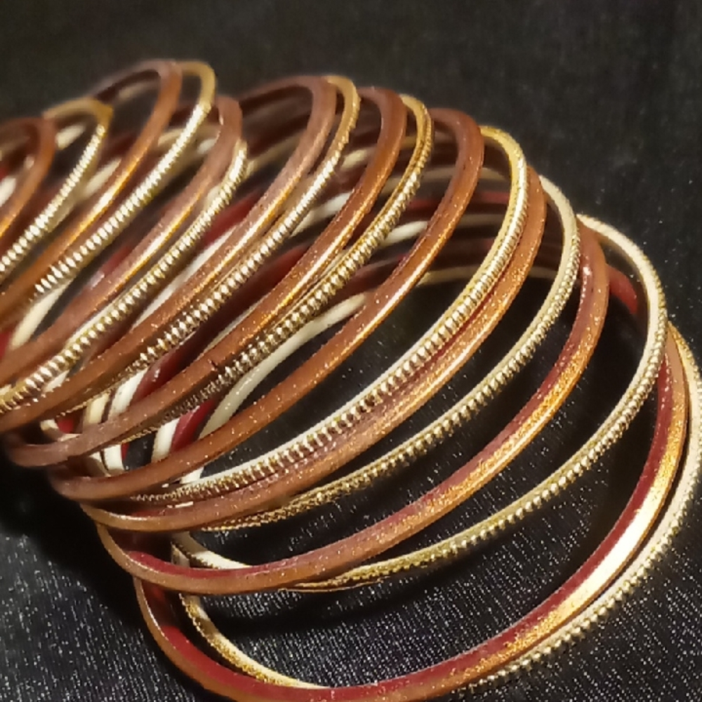 Girls child small 2.25 across Gold and burgundy Bangles 20 in all.